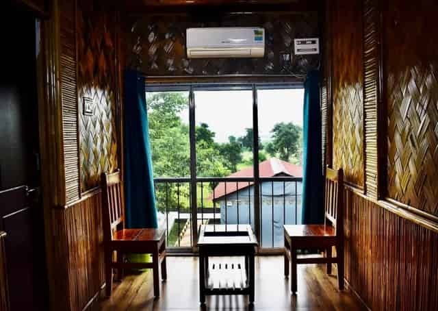 Common seating area of triple bed bamboo cottage , Baranti Eco Stay